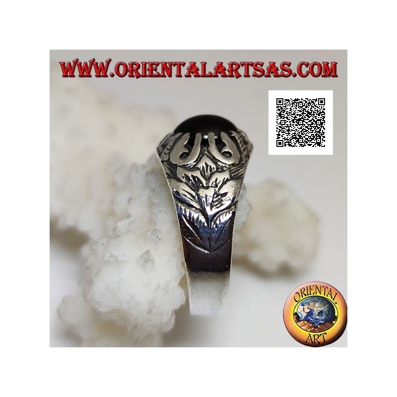 Silver ring with oval cabochon onyx set with claws and embossed floral decorations on the sides