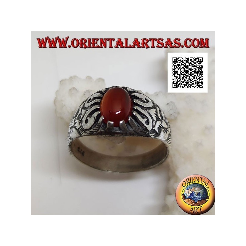 Silver ring with cabochon oval carnelian set with claws and floral decorations in relief on the sides