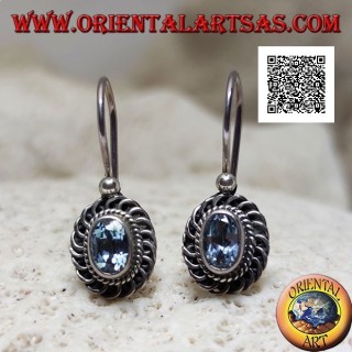 Silver earrings with faceted oval blue topaz surrounded by interweaving and bas-relief quotation marks