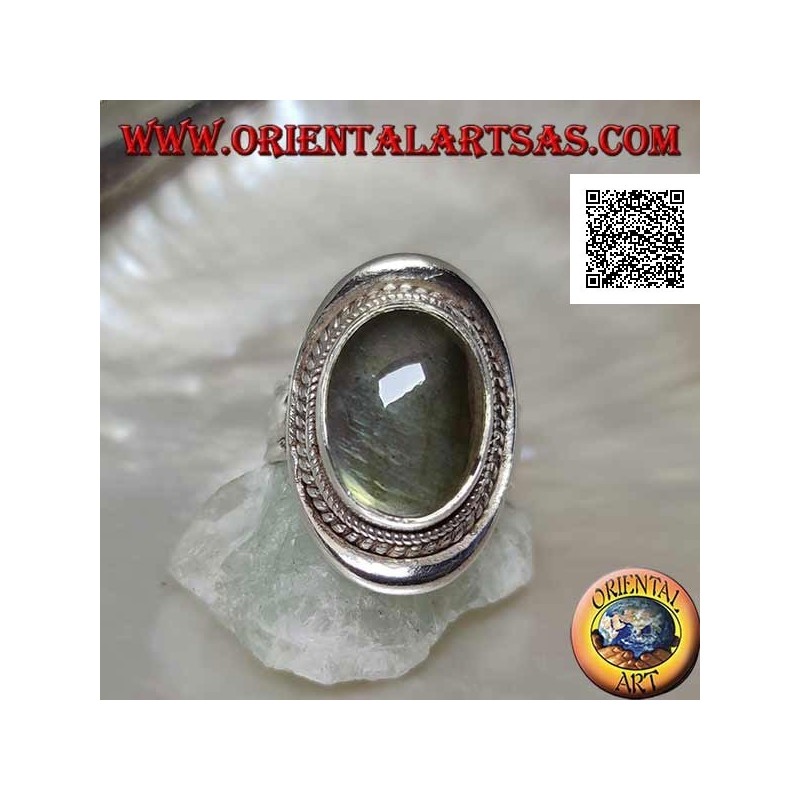 Silver ring with oval cabochon labradorite surrounded by intertwining on a smooth shield (20b)