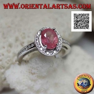 Silver ring with oval natural ruby set with white zircons around and on the side