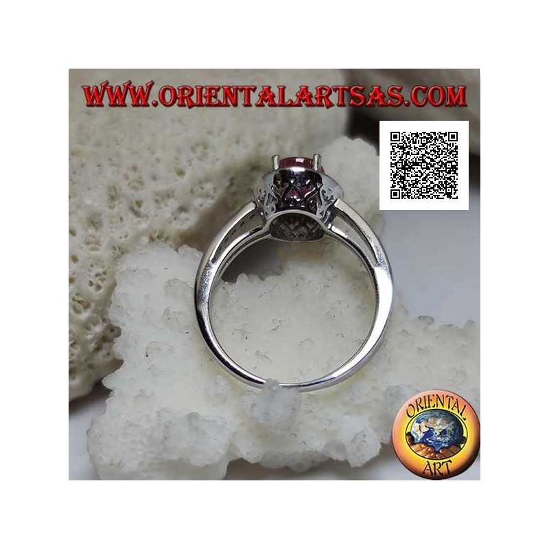 Silver ring with oval natural ruby set with white zircons around and on the side