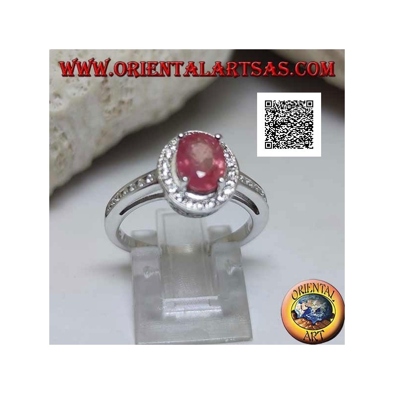 Silver ring with oval natural ruby set with white zircons around and on the side