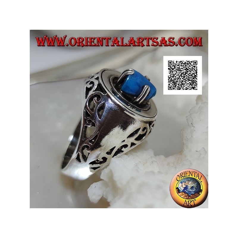 Silver ring with turquoise pyramid set on a smooth disc with floral openwork on the sides