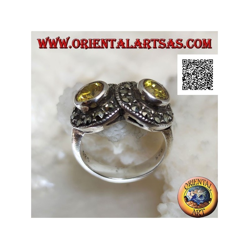 Anillo de plata con dos topacios amarillos redondos en dos círculos tachonados de marcasita que se cruzan