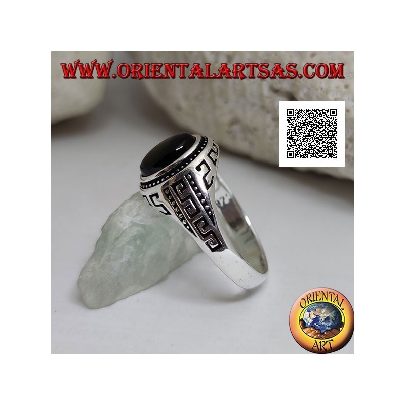 Silver ring with oval cabochon onyx surrounded by disks and S engraved on the sides