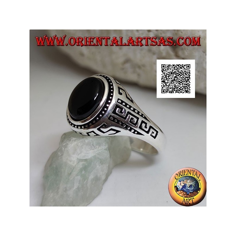 Silver ring with oval cabochon onyx surrounded by disks and S engraved on the sides