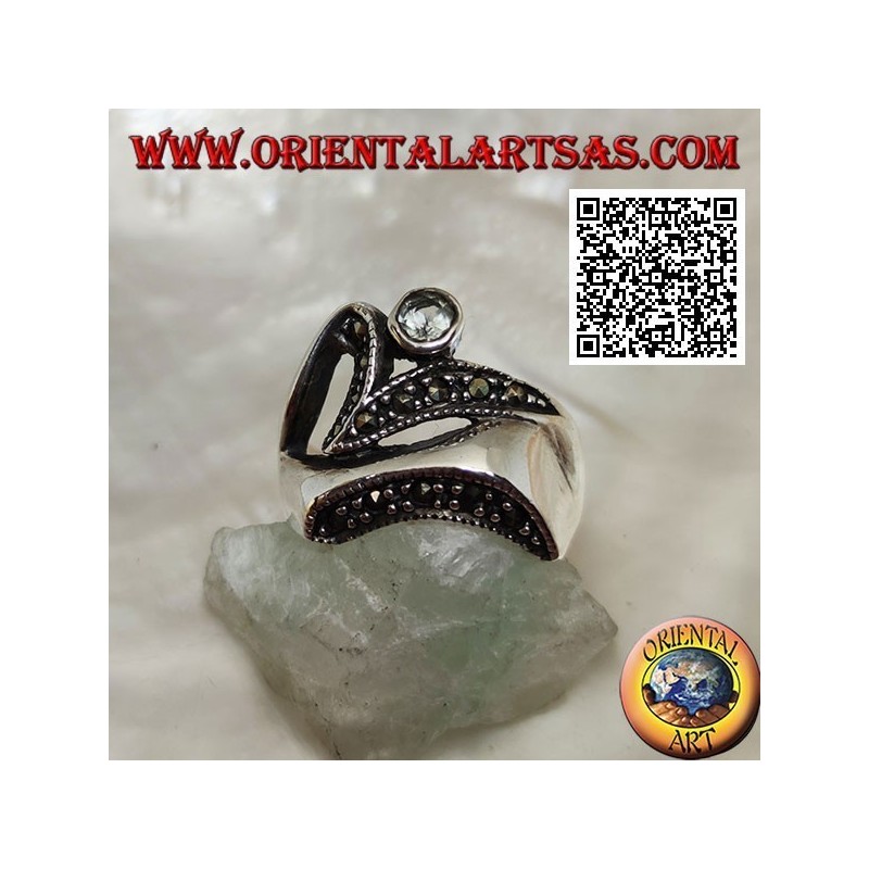 Silver ring of abstract shape in futuristic style with parts of marcasite and round aquamarine