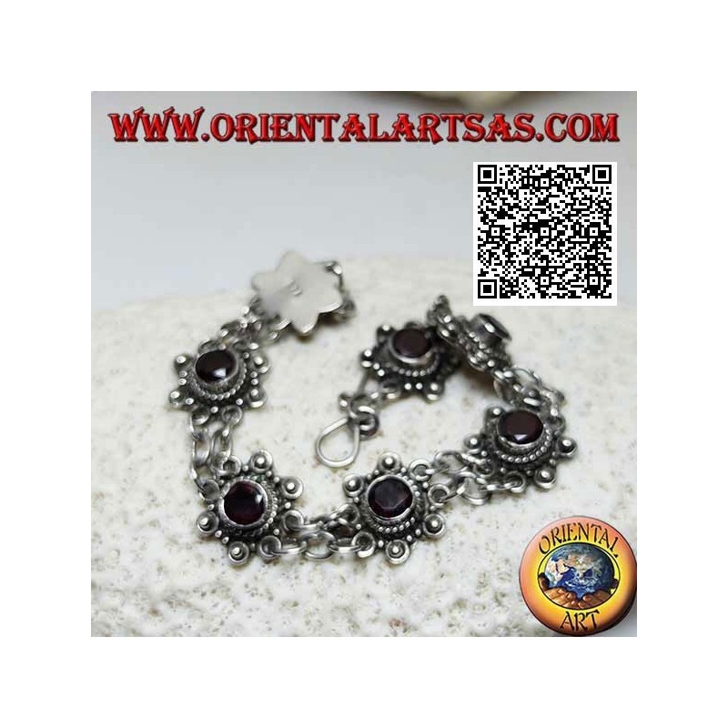 Silver bracelet of 7 flowers with central round faceted garnet joined by two chains