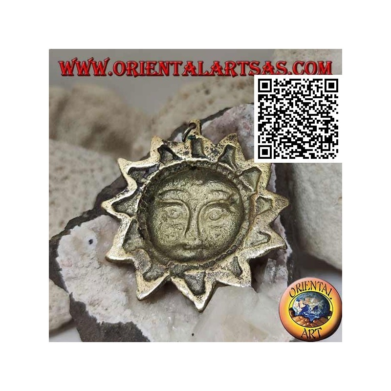 Nepalese pendant in the shape of a sun with a face in relief in brass