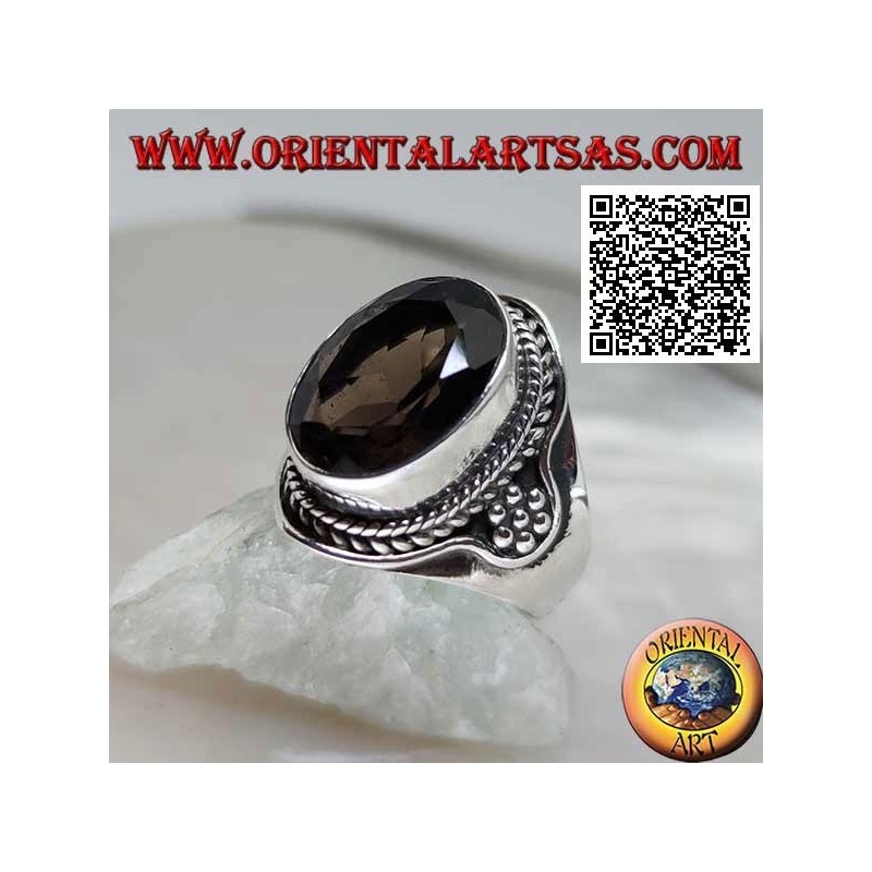 Silver ring with oval faceted smoky topaz surrounded by interweaving and hexagon of balls on the sides