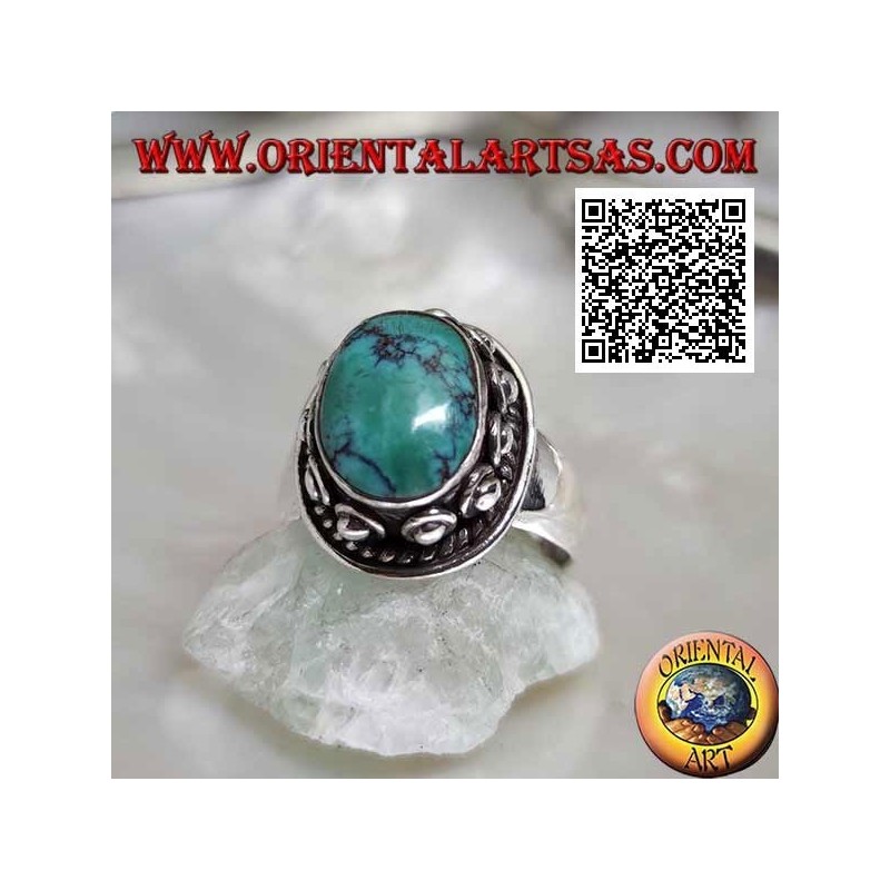Silver ring with antique oval Tibetan turquoise surrounded by interweaving and ball in the donut