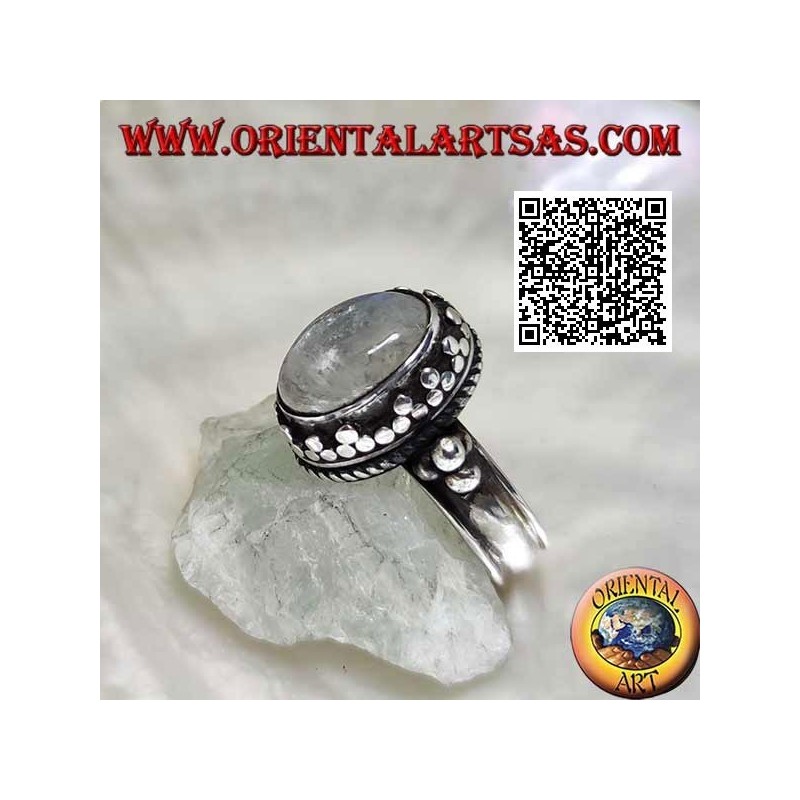 Silver ring with oval rainbow moonstone with tris rim and balls and intertwining