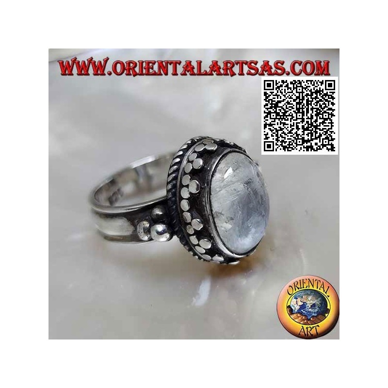 Silver ring with oval rainbow moonstone with tris rim and balls and intertwining
