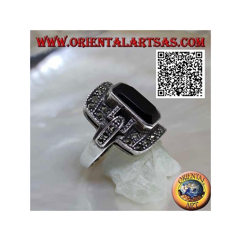 Silver ring with baguette cut onyx on rectangular frame and hooks studded with marcasite