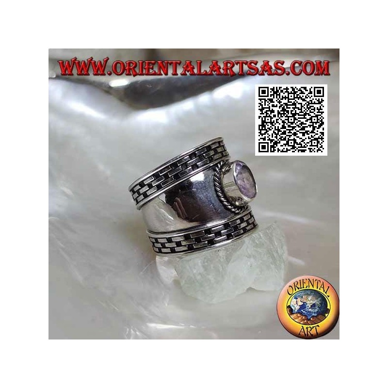 Wide band silver ring with oval faceted amethyst and hatching on the edges
