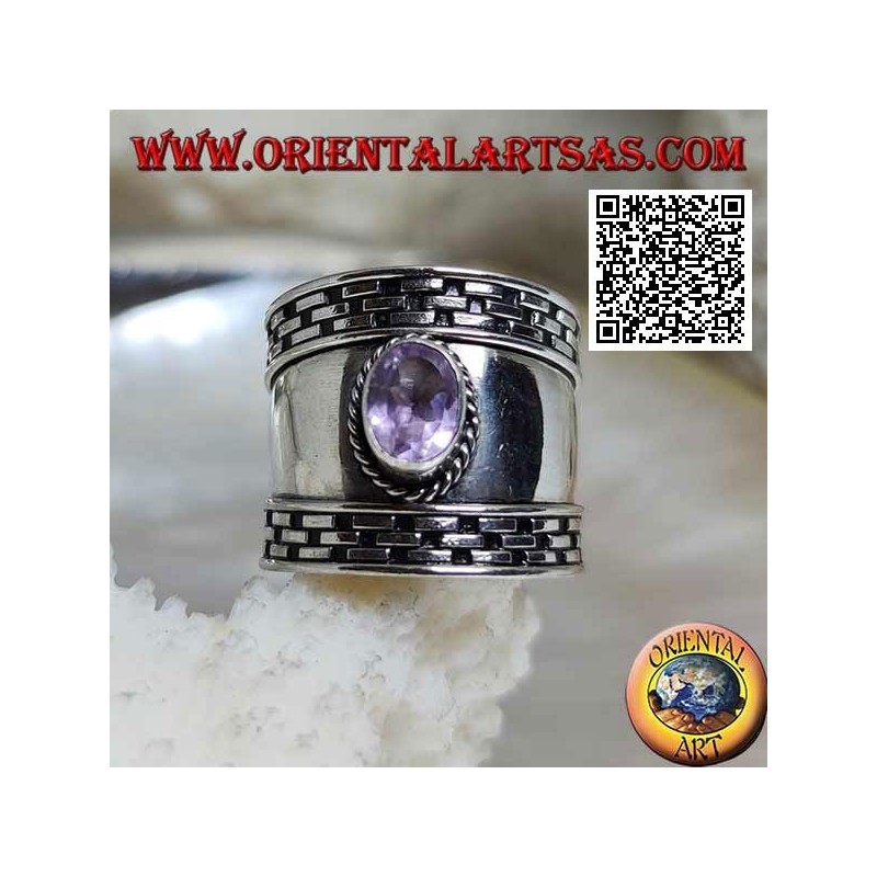 Wide band silver ring with oval faceted amethyst and hatching on the edges