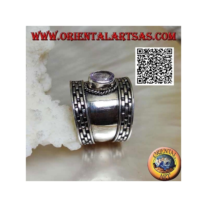 Wide band silver ring with oval faceted amethyst and hatching on the edges