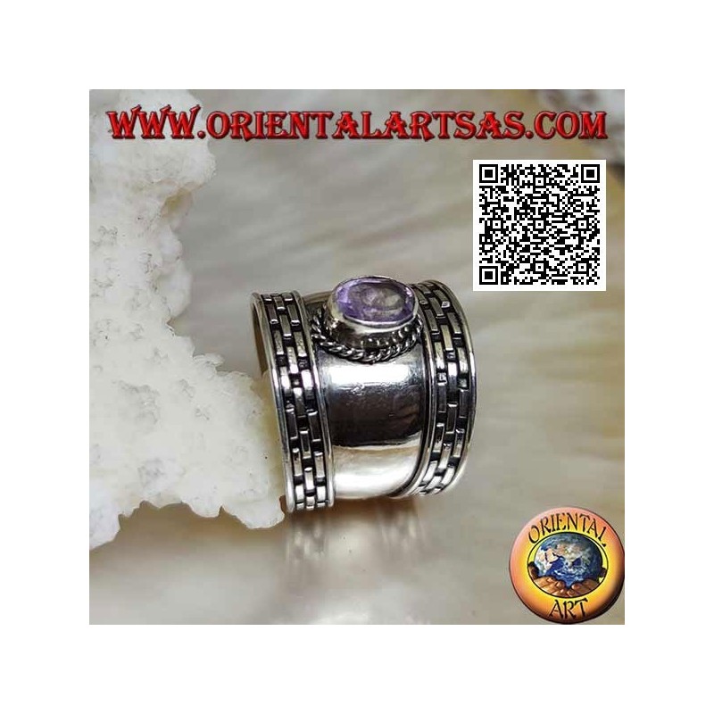 Wide band silver ring with oval faceted amethyst and hatching on the edges