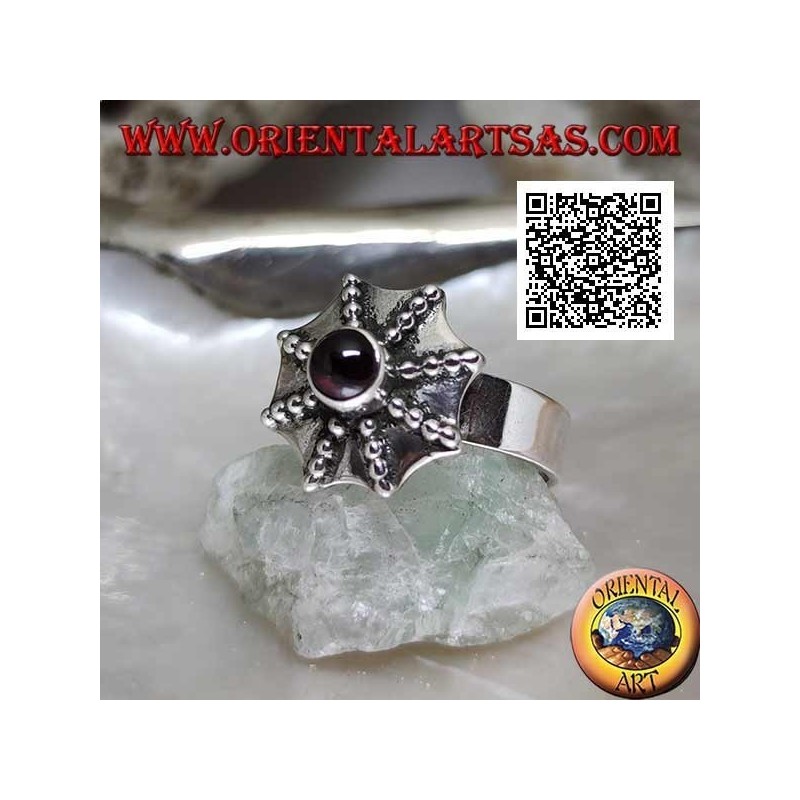 Silver ring in the shape of a pagoda umbrella with a central round garnet
