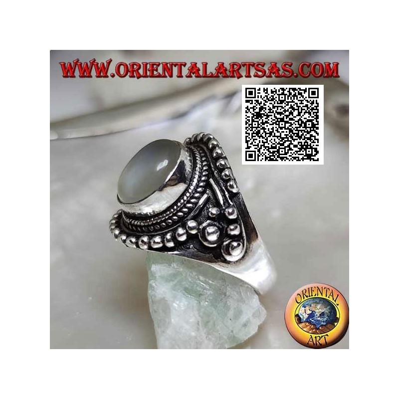 Silver ring with oval moonstone on ethnic setting decorated with intertwining and balls