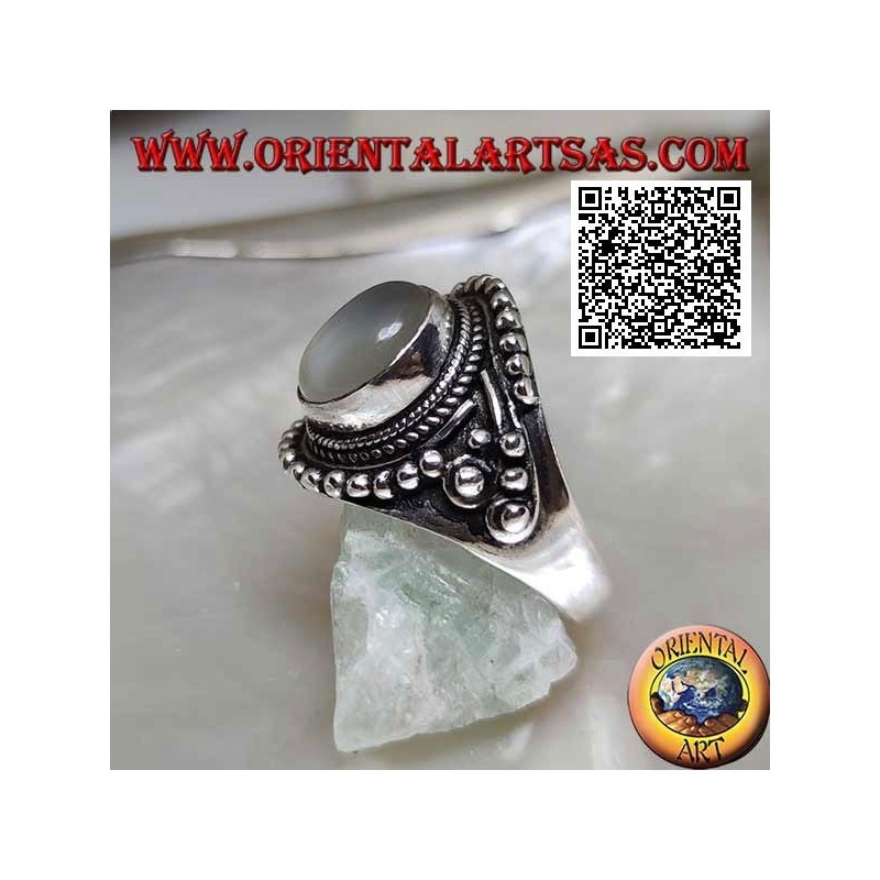 Silver ring with oval moonstone on ethnic setting decorated with intertwining and balls