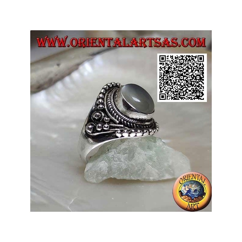 Silver ring with oval moonstone on ethnic setting decorated with intertwining and balls