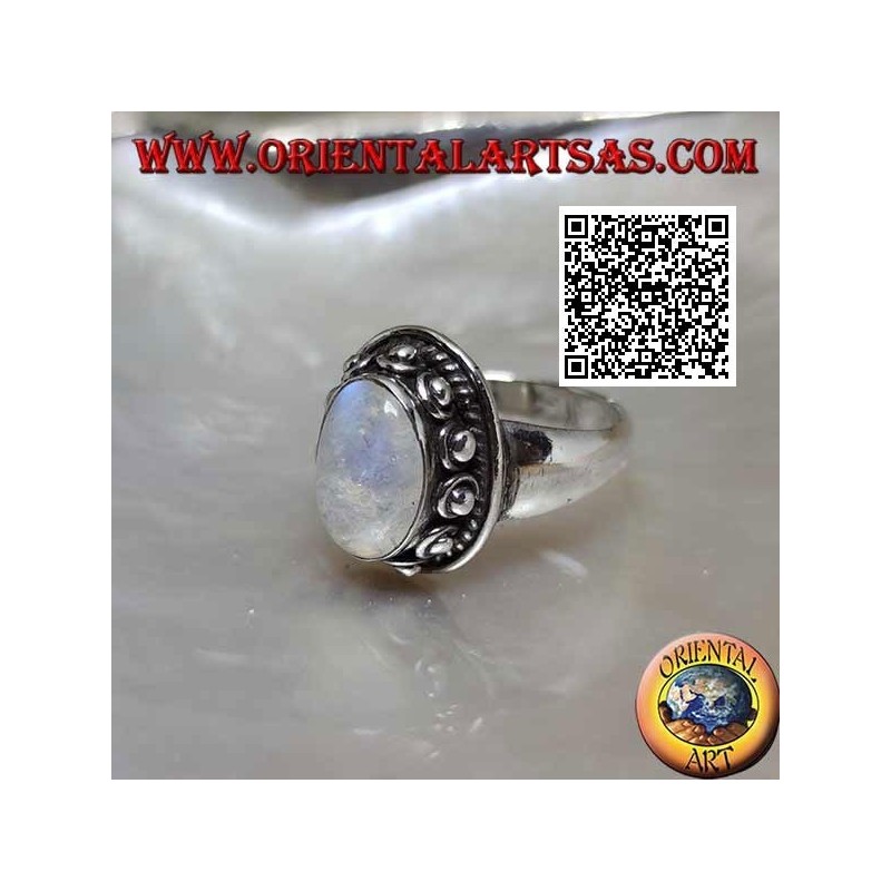 Silver ring with oval moonstone surrounded by interweaving and ball in the donut