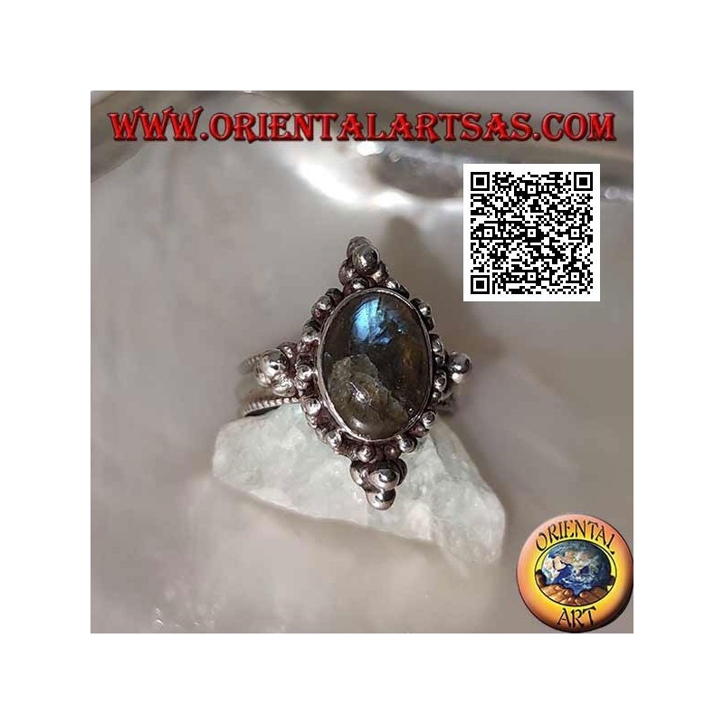 Silver ring with oval cabochon labradorite on a setting decorated with balls
