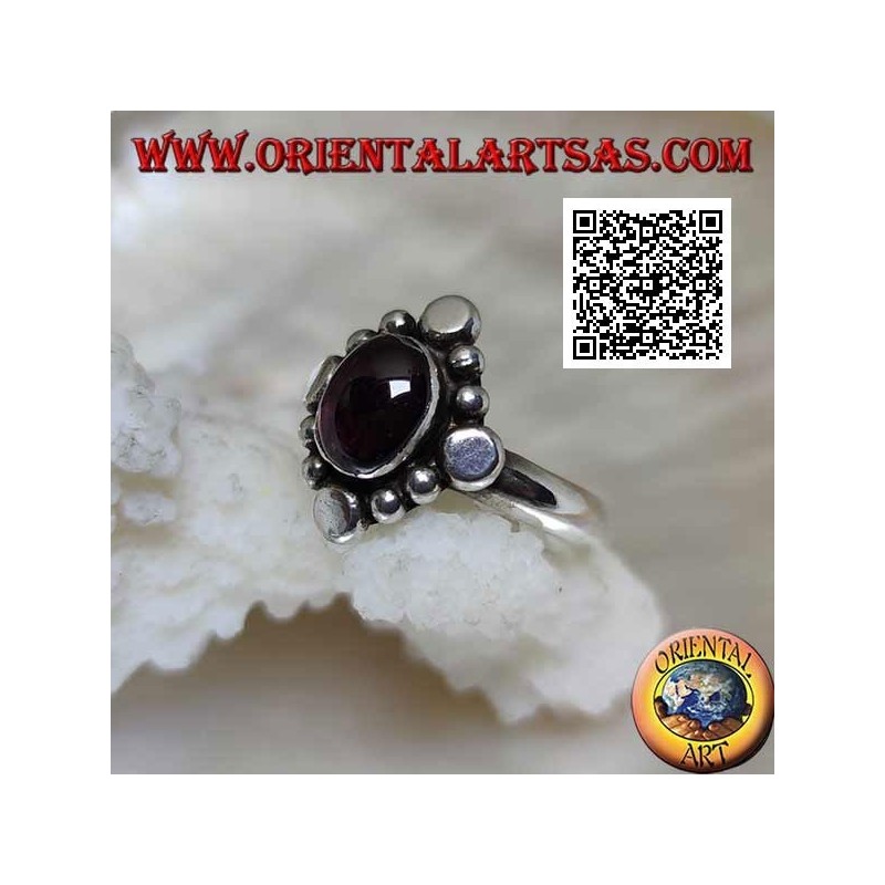 Silver ring with oval cabochon garnet surrounded by alternating studs and balls