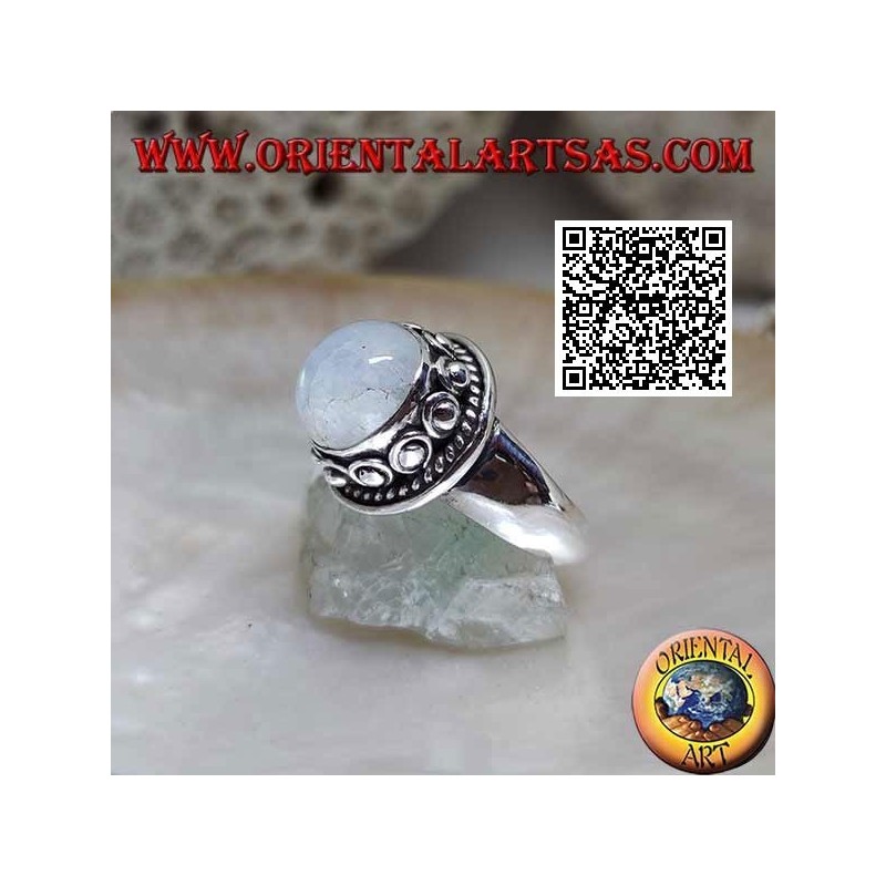 Silver ring with round moonstone surrounded by interweaving and ball in the donut