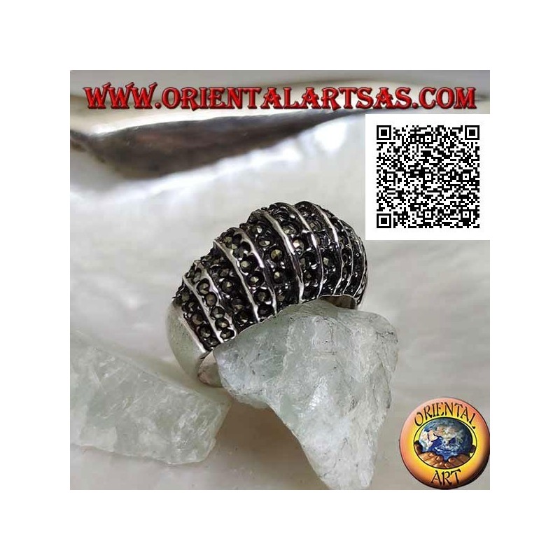 Silver ring with a rounded band on the front cut by vertical lines and studded with marcasite