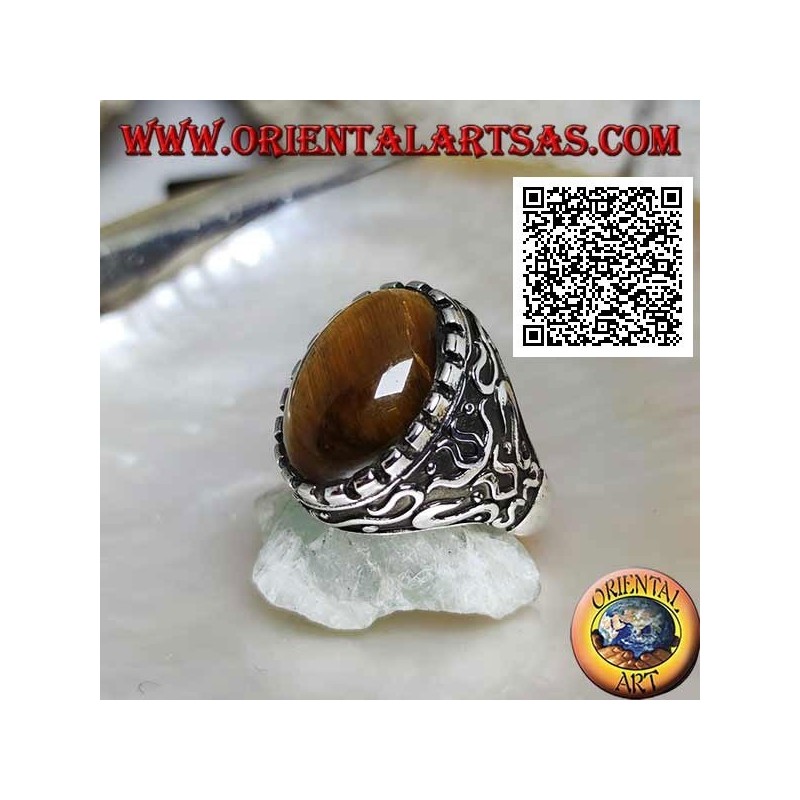 Silver ring with large cabochon oval tiger eye surrounded by mystical bas-relief decorations