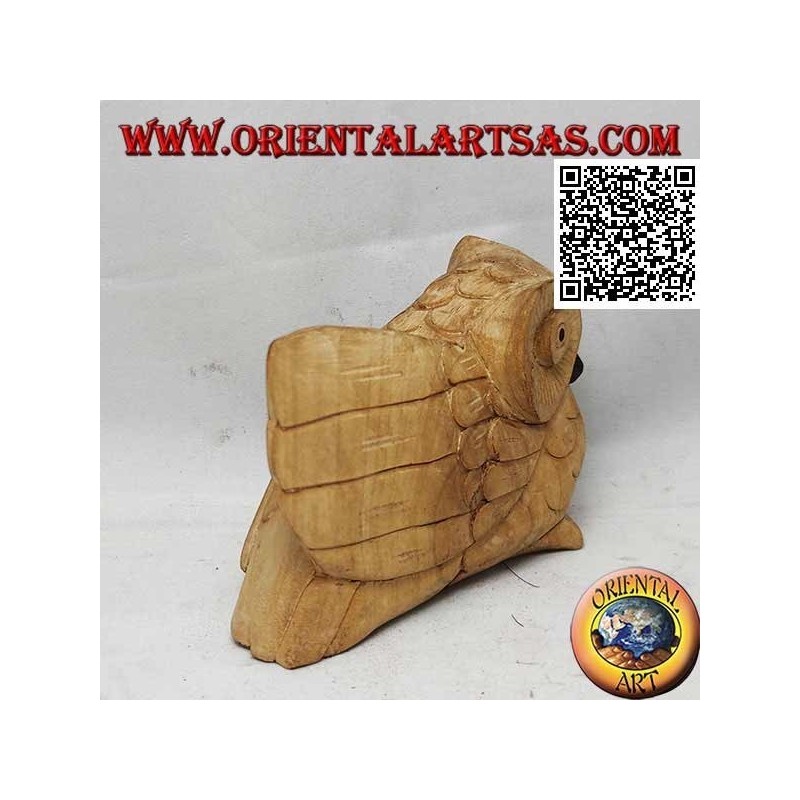 Sculpture of a three-quarter owl with an outstretched wing in hibiscus wood