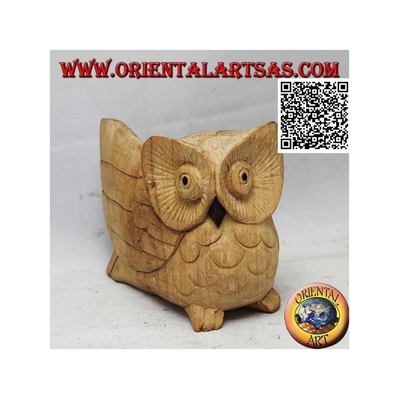 Sculpture of a three-quarter owl with an outstretched wing in hibiscus wood