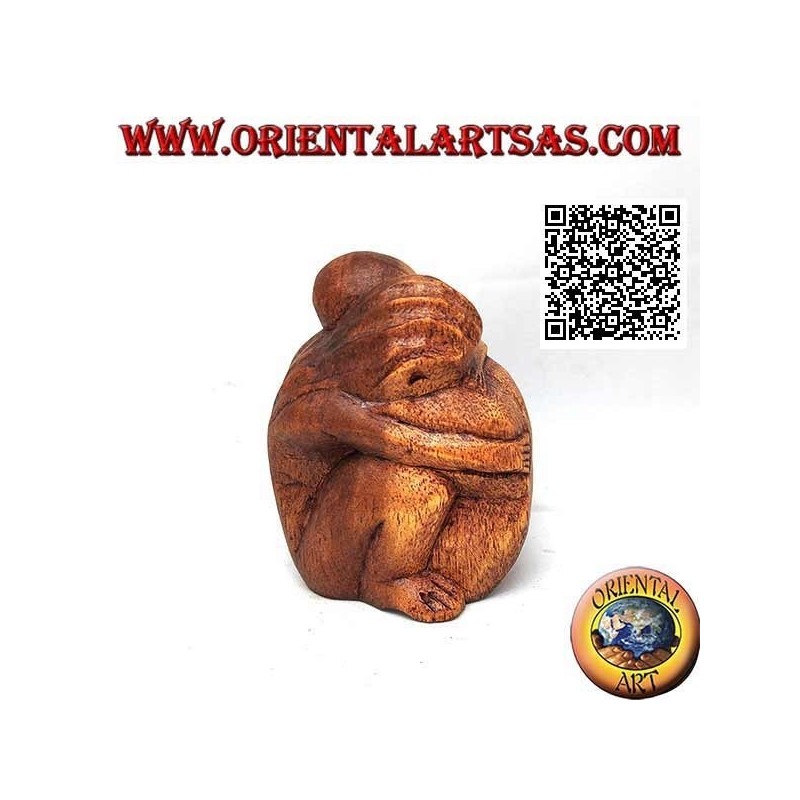 10 cm sculpture of a couple in consoling embrace in suar wood