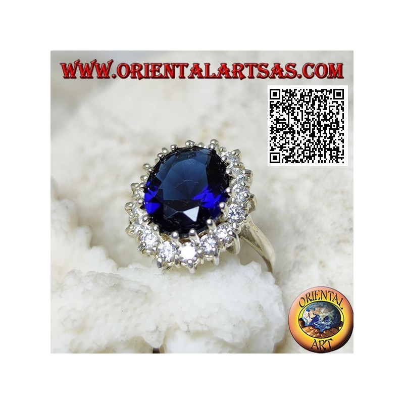 Anillo de plata con zafiro sintético ovalado facetado engastado rodeado de circonitas blancas