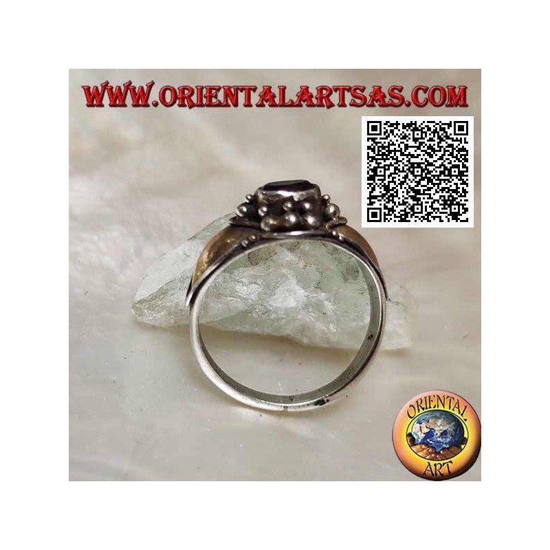 Silver ring with horizontal oval amethyst with balls above and below and 14 karat gold plates on the sides
