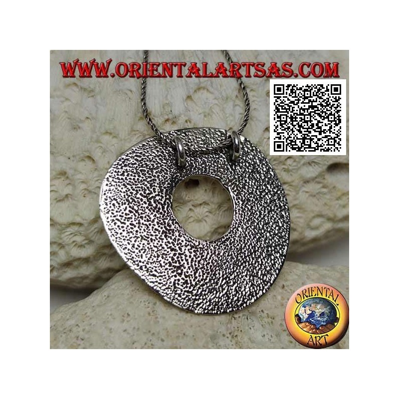 Smooth silver pendant in the shape of a large irregular disc in the Neolithic rock style