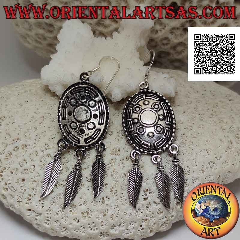 Silver leverback earrings with oval ethnic shield decorated in relief and hanging feathers