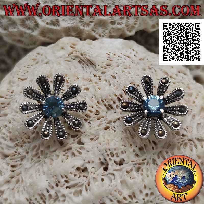 Silver lobe earrings in the shape of a large daisy studded with marcasite and central round blue topaz
