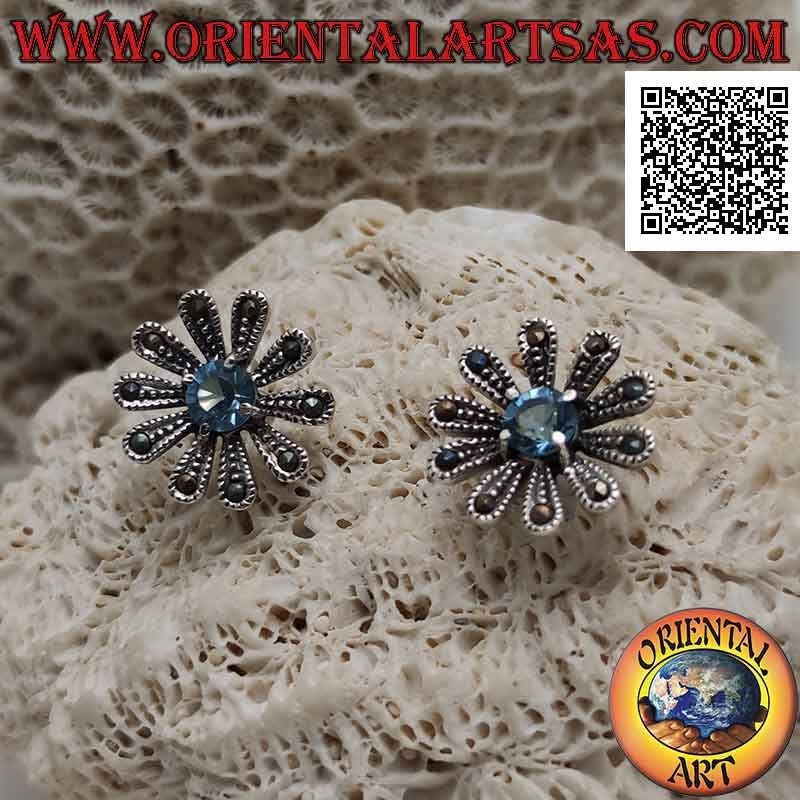 Silver lobe earrings in the shape of a large daisy studded with marcasite and central round blue topaz