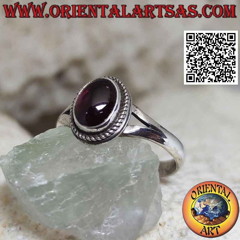 Silver ring with natural oval cabochon garnet surrounded by weaving