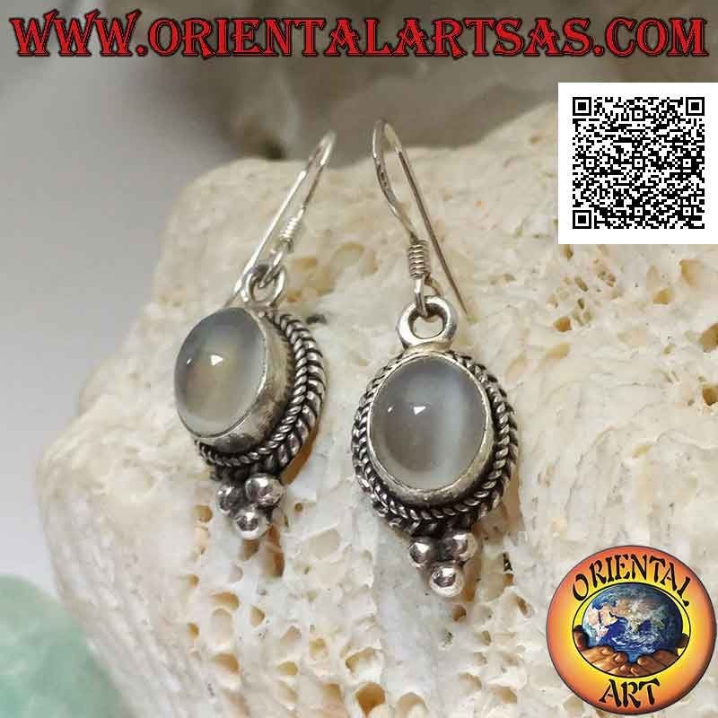 Silver earrings with cabochon oval moonstone surrounded by interweaving and trio of balls below