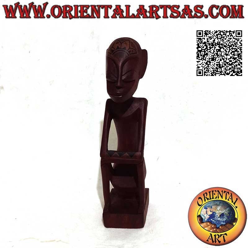 Sculpture of an indigenous thinker with hand painted tribal tattoos in burgundy mahogany wood