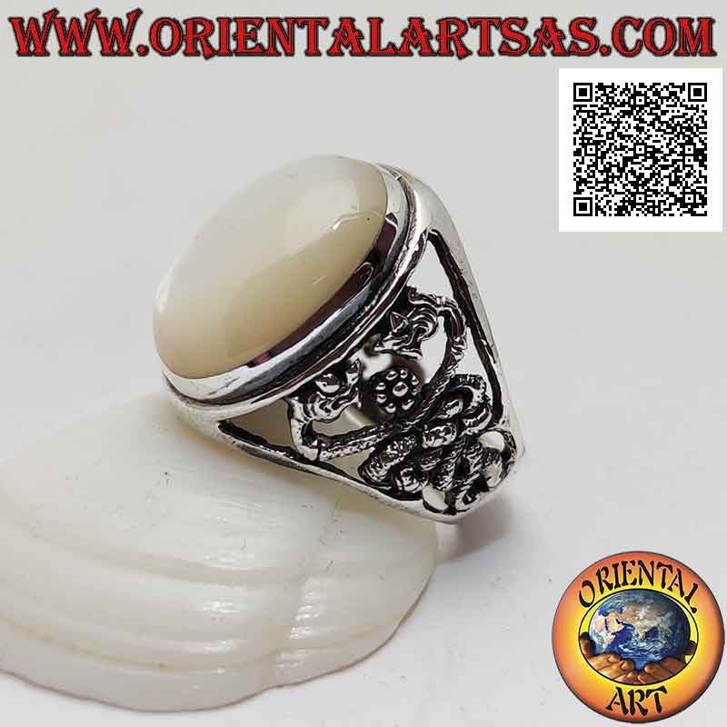 Silver ring with oval cabochon mother-of-pearl and double dragon intertwined on a perforated background on the sides