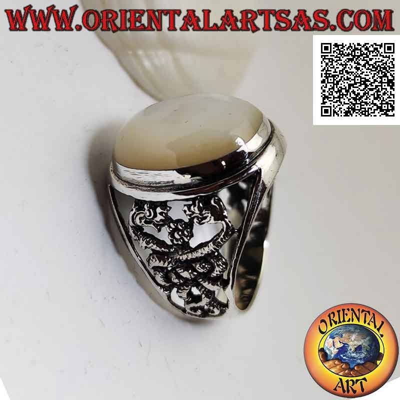 Silver ring with oval cabochon mother-of-pearl and double dragon intertwined on a perforated background on the sides