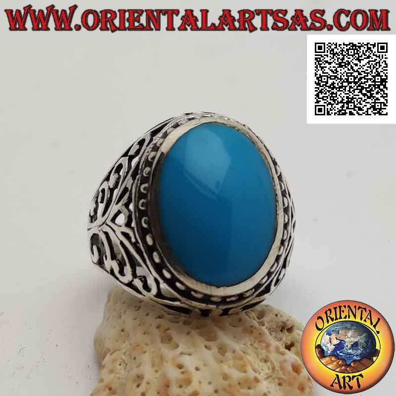 Silver ring with oval cabochon turquoise surrounded by dots and perforated baroque decoration on the sides
