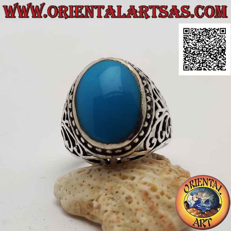 Silver ring with oval cabochon turquoise surrounded by dots and perforated baroque decoration on the sides