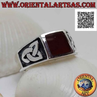 Silver ring with square carnelian flush with the edge and bas-relief triquetra on the sides